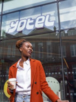 Woman in front of hotel 