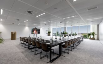 a meeting room with tables looks over the lake